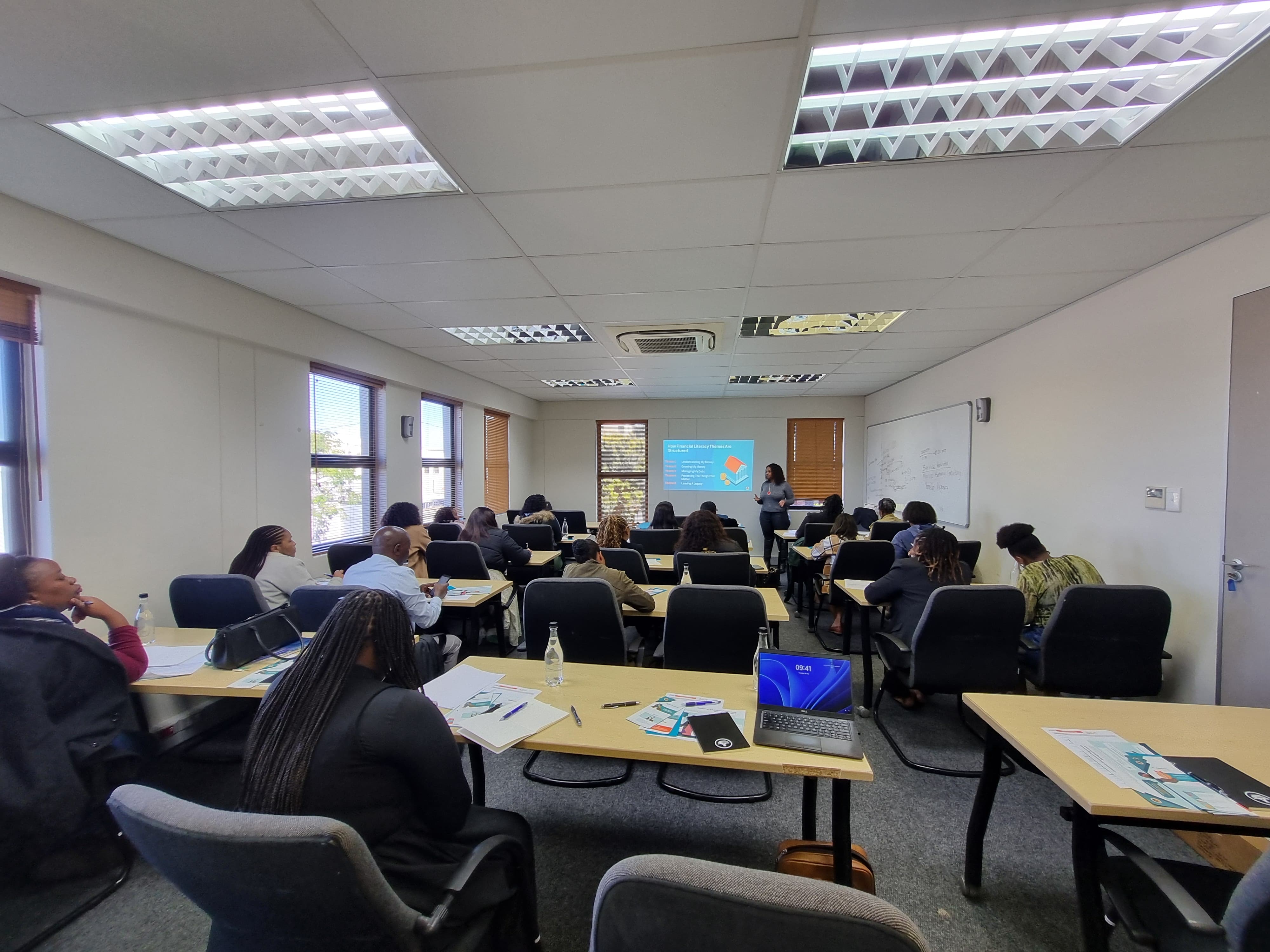 Participants working with laptops and digital tools